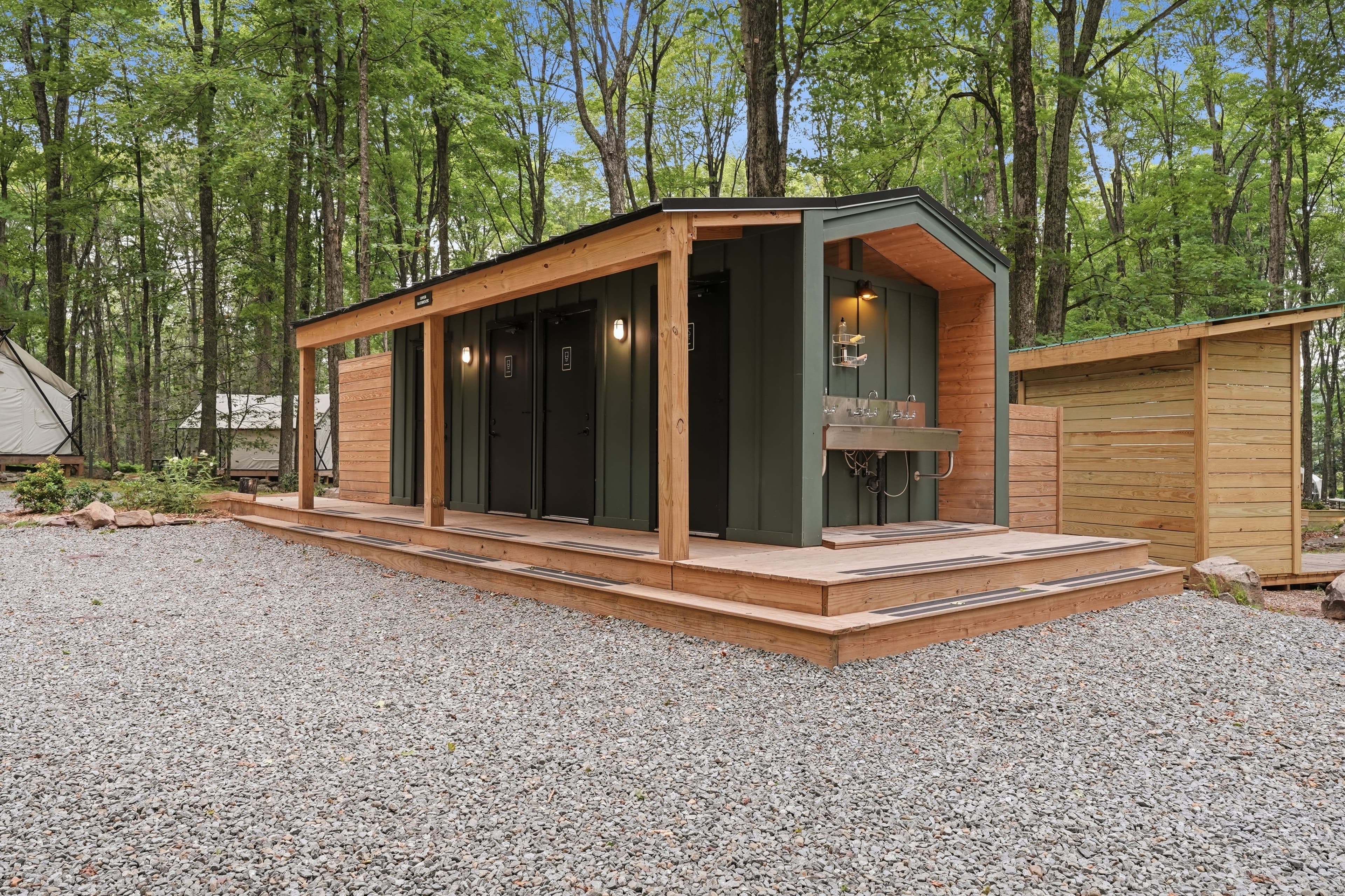 A modern Ferncrest bathhouse building tucked into the trees