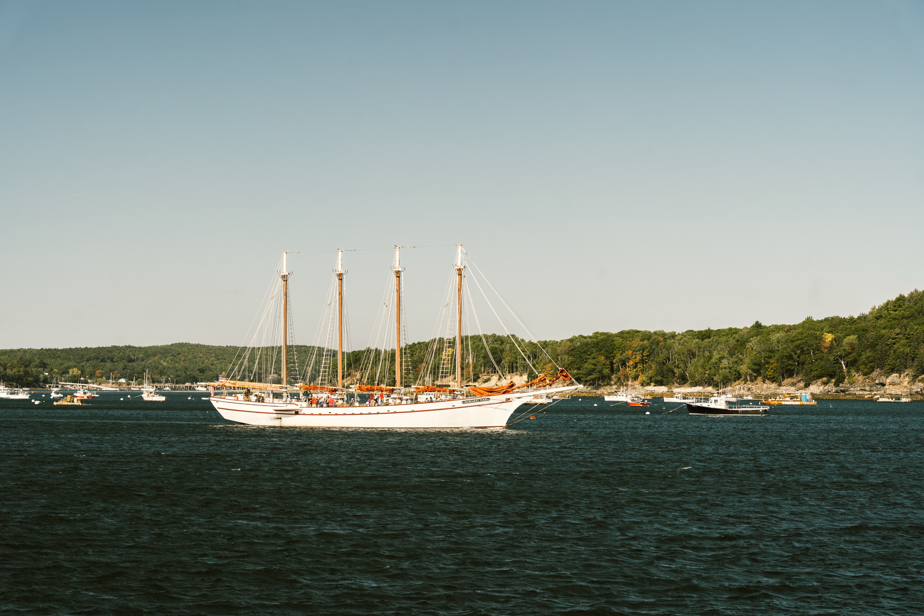 A four-masted schooner anchored in the harbor