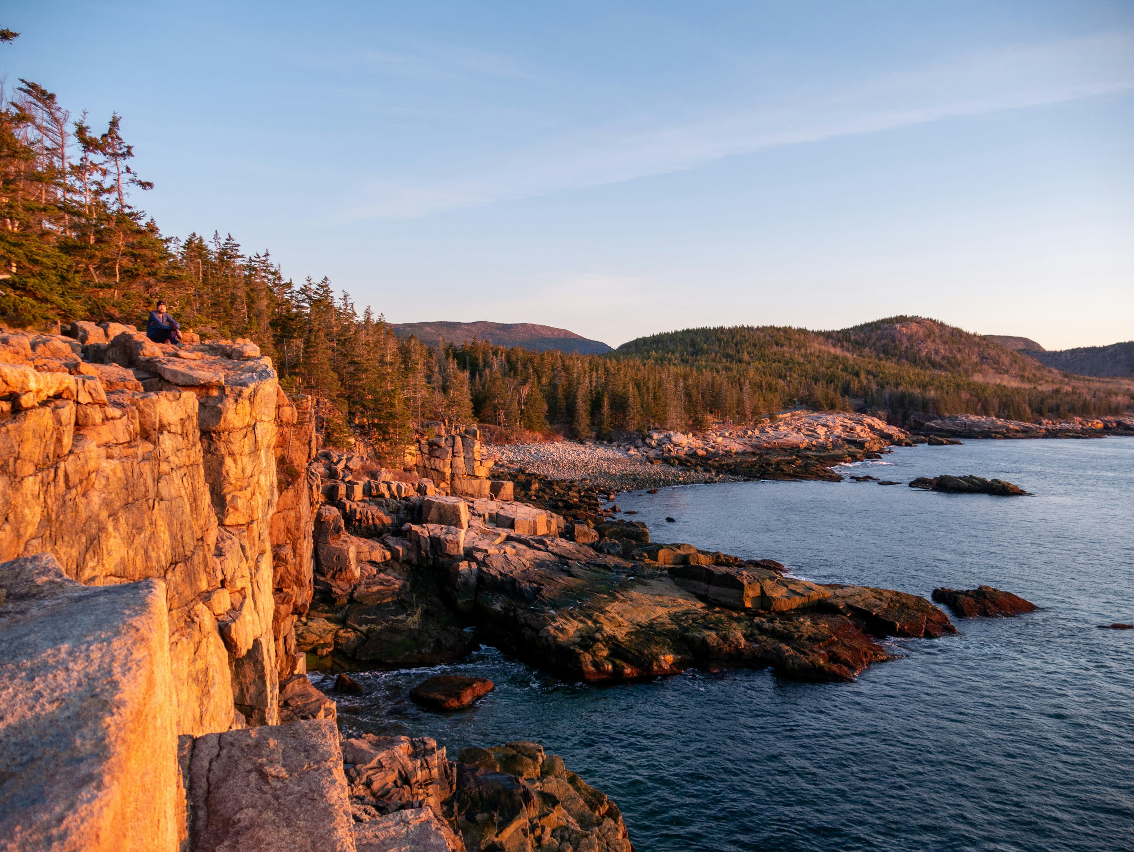 Golden light on the granite cliffs along the Acadia coastline