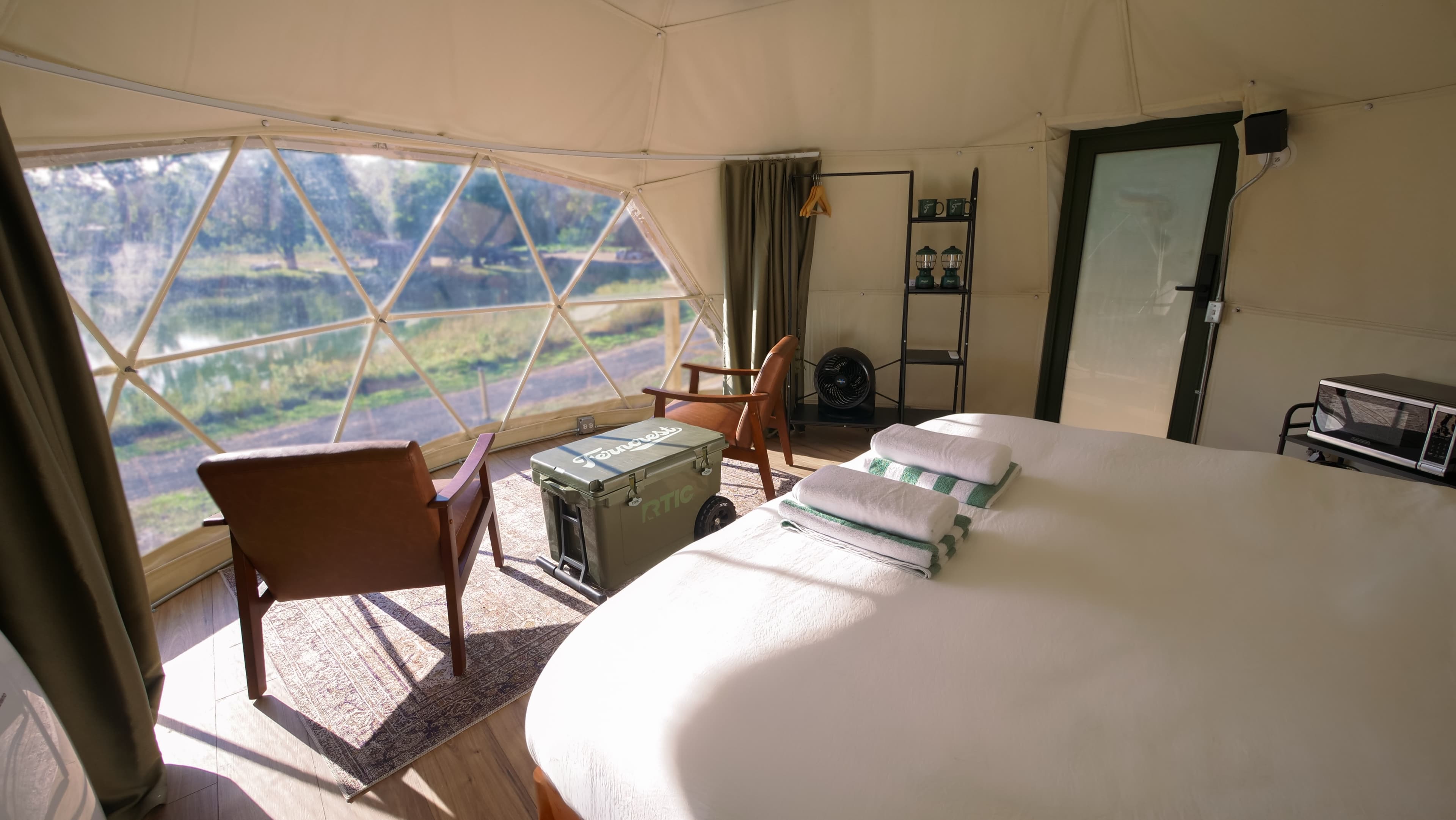 The king bed in a Classic Dome, facing the window and the lake