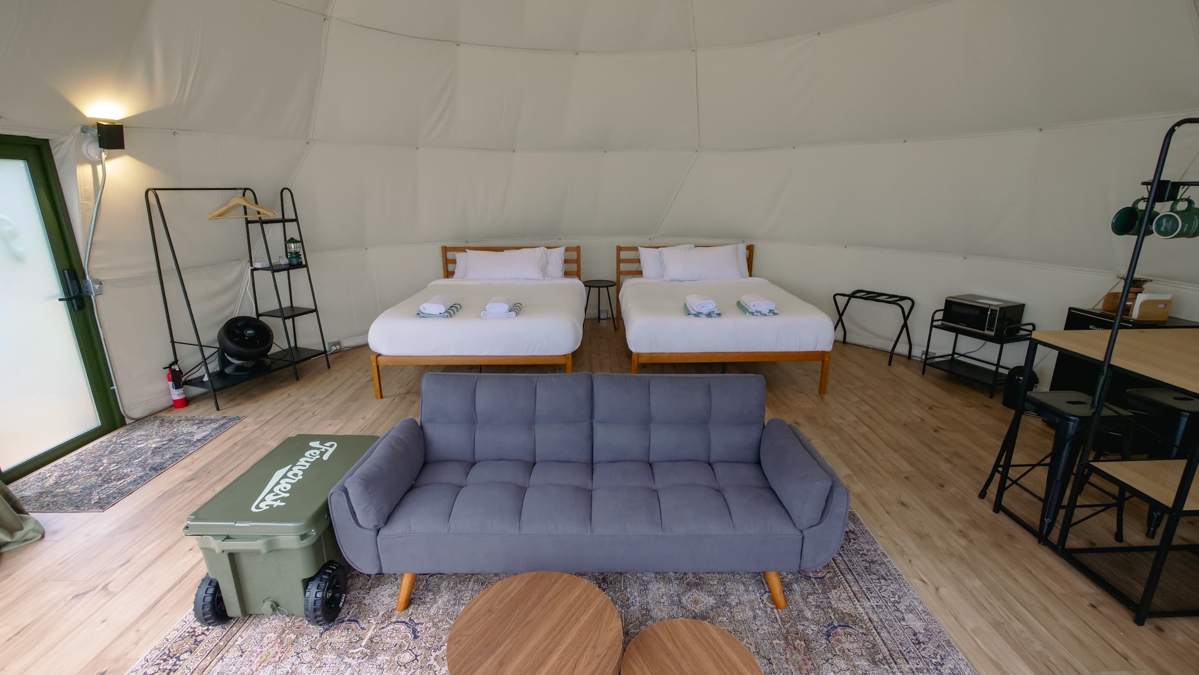 Two queen beds and a futon sofa inside a Family Dome
