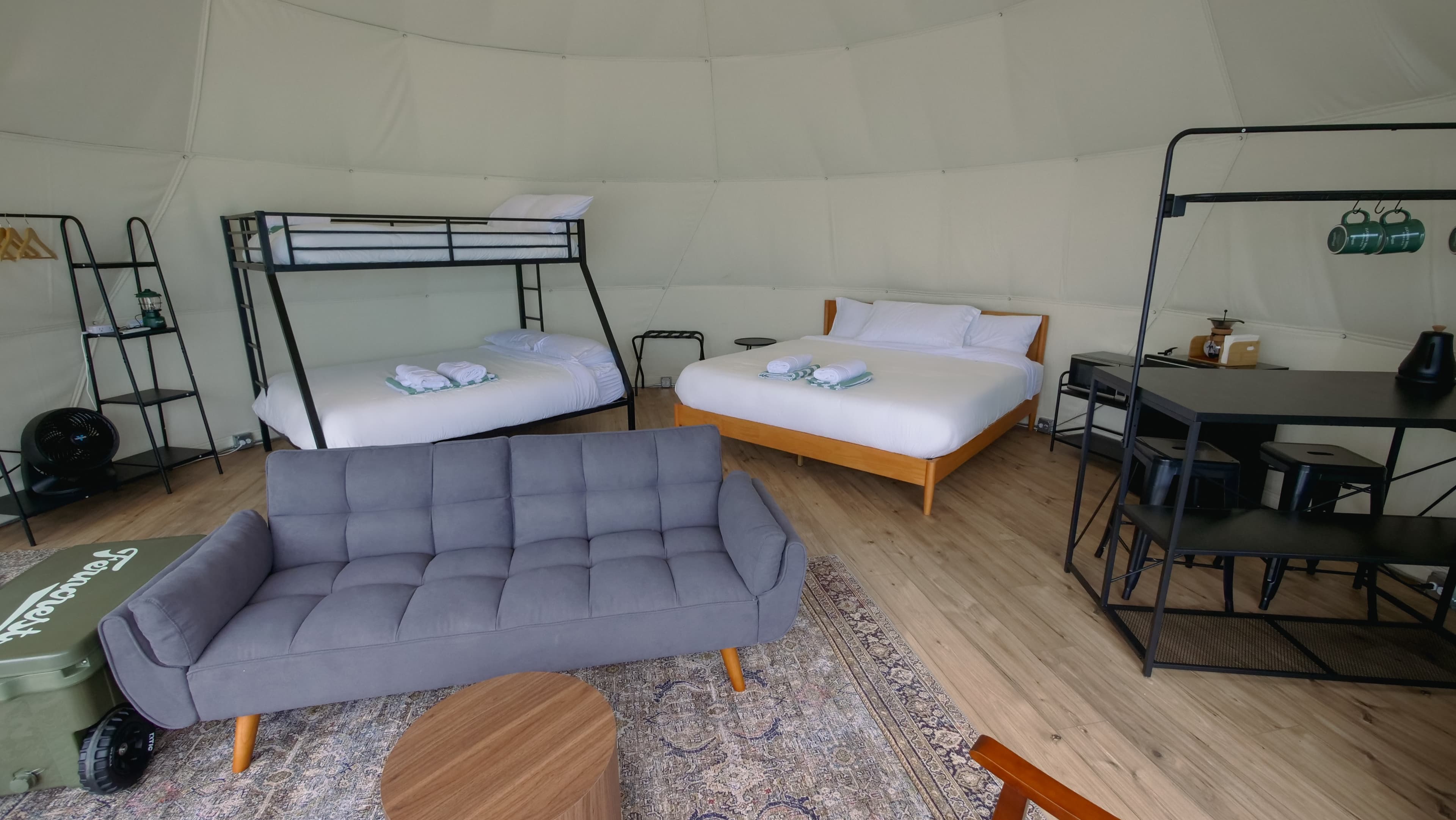 Bunk beds, a king bed and a futon sofa inside a Family Dome